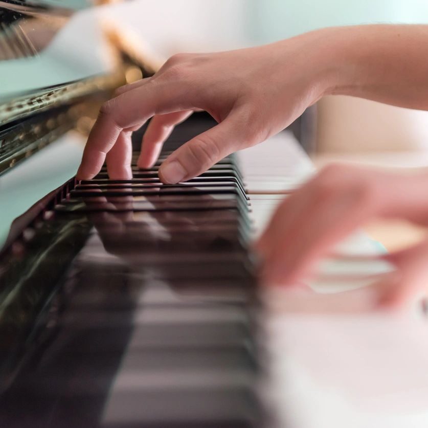 mother and child playing piano